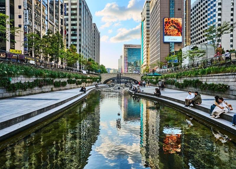 Before #WCLC26, walk Cheonggyecheon at dusk. Buried under a highway in 1971, dug back out